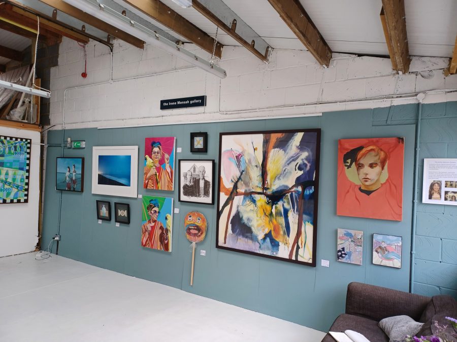A view of our gallery during a group exhibition showing a range of figurative and abstract paintings.