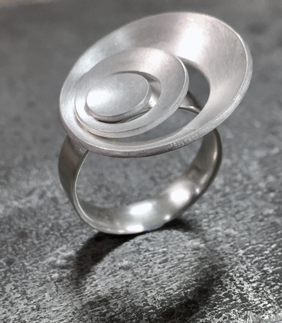Silver ring with a spiral like top
