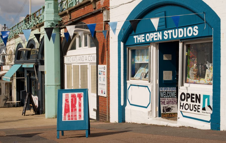 An image of the entrance of the open house studios, a blue arch with white walls and an open door