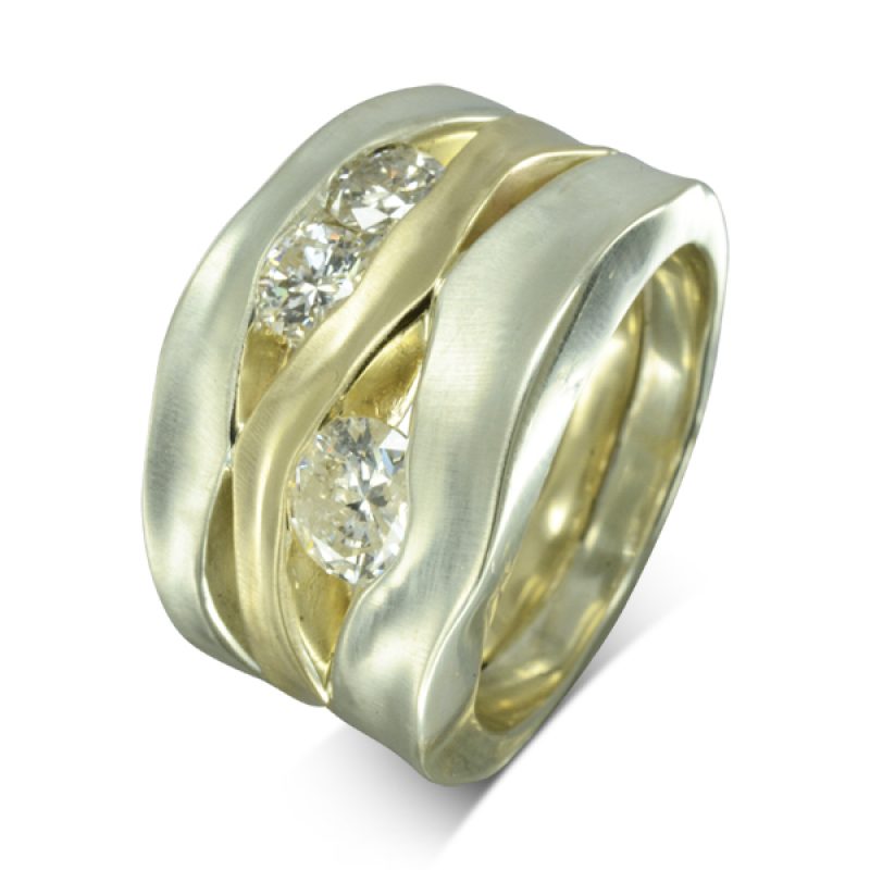 This ring is 15mm wide at the front, comprised of 5mm and 6mm white gold side hammered bands with a 3mm yellow gold centre soldered together and is set with 1ct of round diamonds in between the bands.