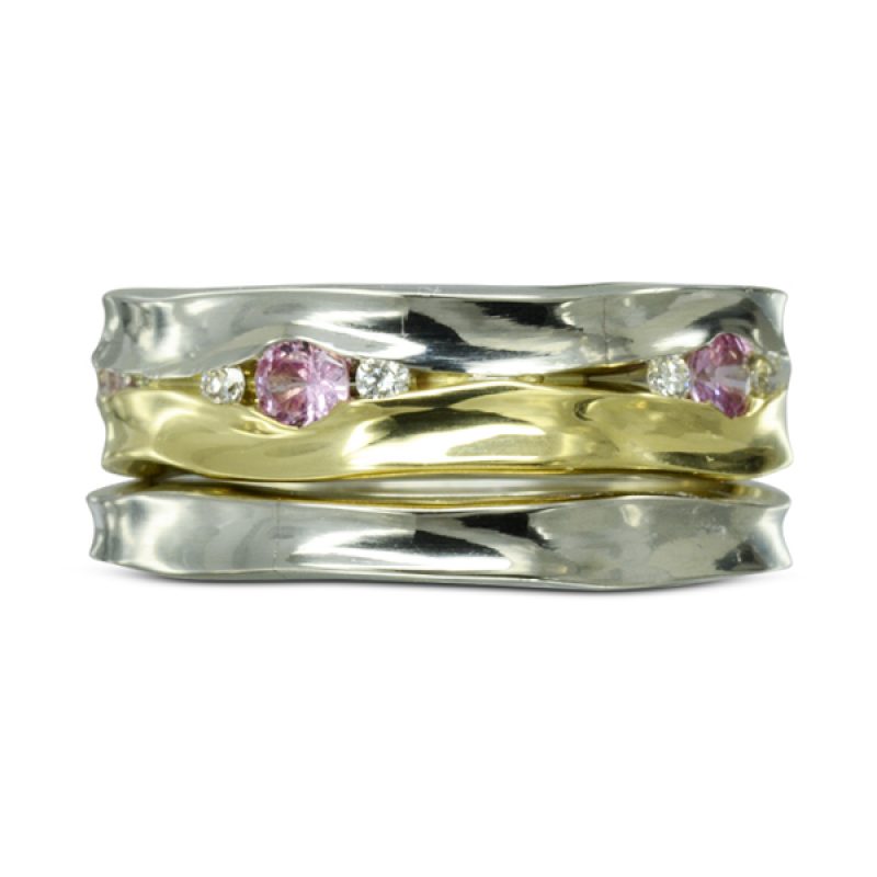 6mm wide, comprised of two 3mm side hammered bands soldered together in platinum and 18ct yellow gold, set with 10 1.5mm round diamonds and five 0.10pt pink sapphires in between the two bands. With a matching 3mm side hammered platinum wedding band.