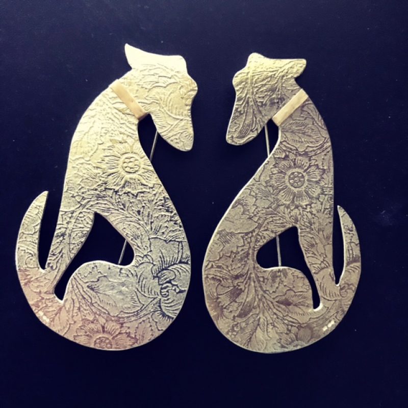 two silver dog brooches