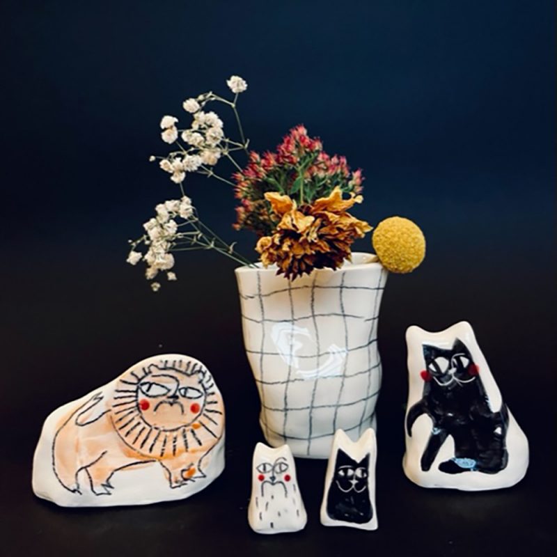 A selection of illustrated ceramics with cats on them