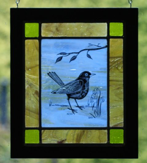 Green and Blue Stained Glass panel with a Blackbird etched onto it.