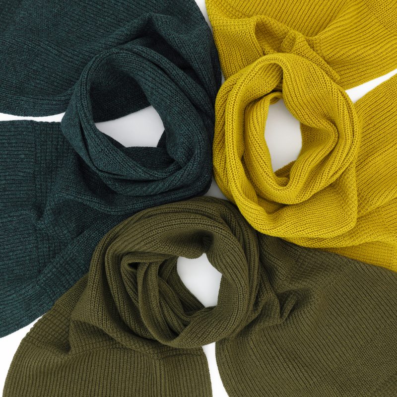 Three knitted lambswool scarfs of different colours, one in piccalilli, one in olive dun and one in Lugano