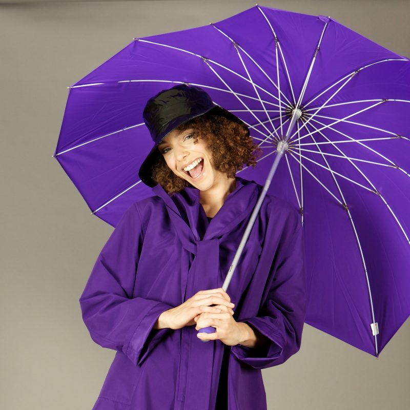 Lady wearing Purple raincoat with matching umbrella