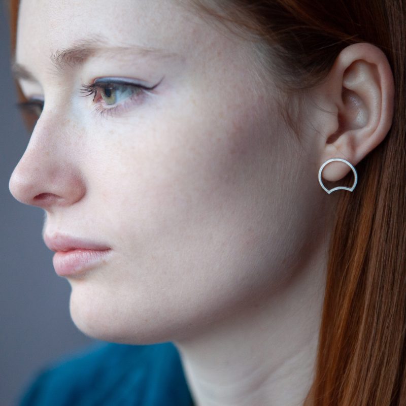 A model wearing silver earrings