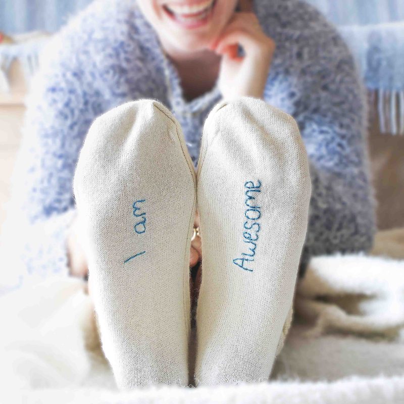 Wool bed socks with the words, 'Eat, Sleep, Swim Repeat' embroidered on the soles. 