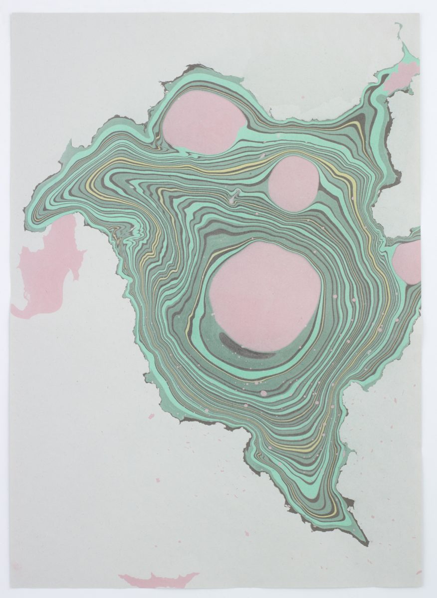 Suminagashi print taken from the surface if the water. Image is greens and pinks 