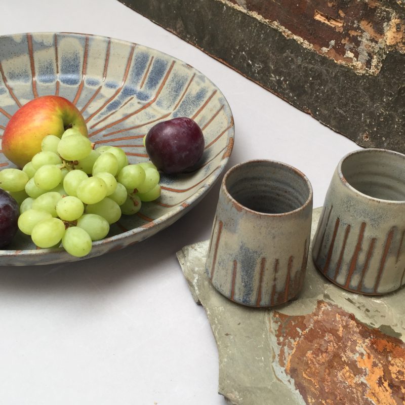 Platter and drinking vessels made from clay in colours of chalk and flint. The natural clay colours captured beautifully in useful dining ware.