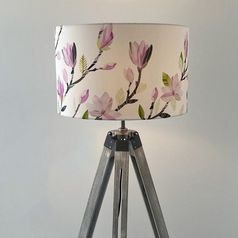 Lamp shade with decorative pink magnolia flowers.