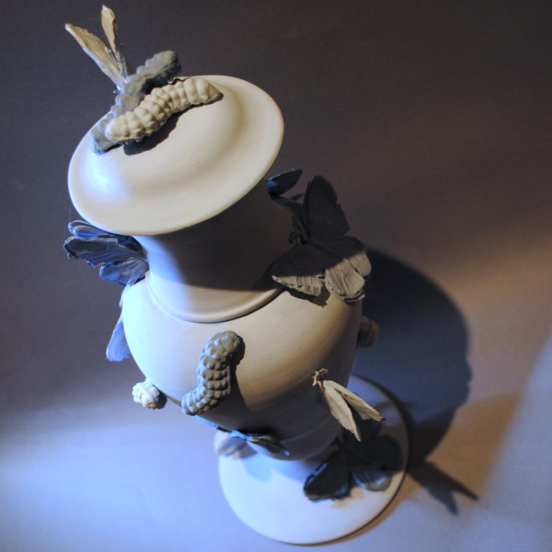 Porcelain vessel with lid, in three shades of blue, wheel thrown assemblage, decorated with butterfly and caterpillar sprig moulds.