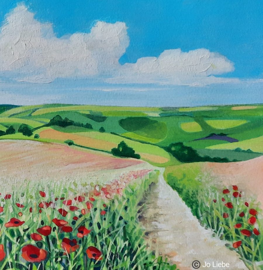 Poppies in the foreground give way to a path taking you through the fields and up on to the Downs. Fields of green and golden yellow below the blue sky and fluffy white clouds. Idyllic Sussex. You can almost feel the gentle breeze and warm sunshine.