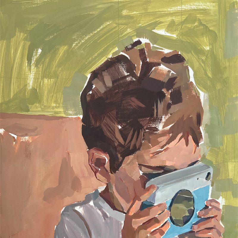 Portrait of a young boy with a camera 