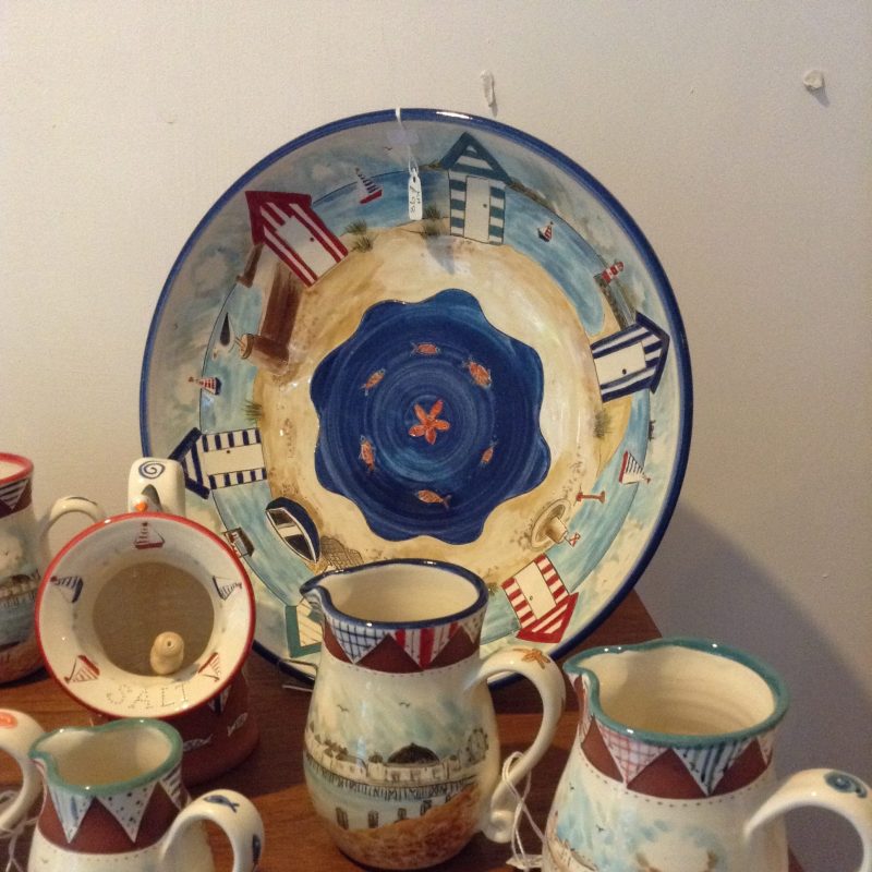 Collection of ceramics with images of the beach and sea.