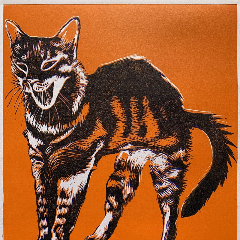 A reduction lino print of a cat stretching in blue and orange.