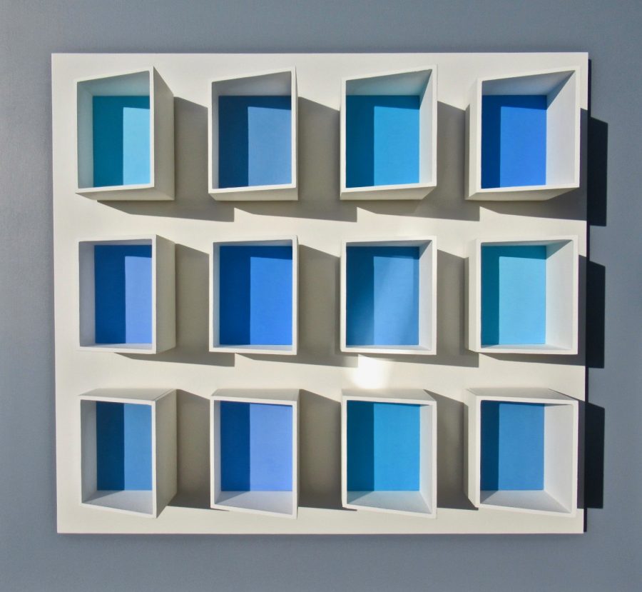 Twelve raised box projections in a 4x3 configuration.  The base of each box is painted blue.