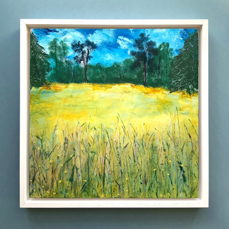 Landscape painting of a buttercup field with a magical twilight sky in wooden frame painted white