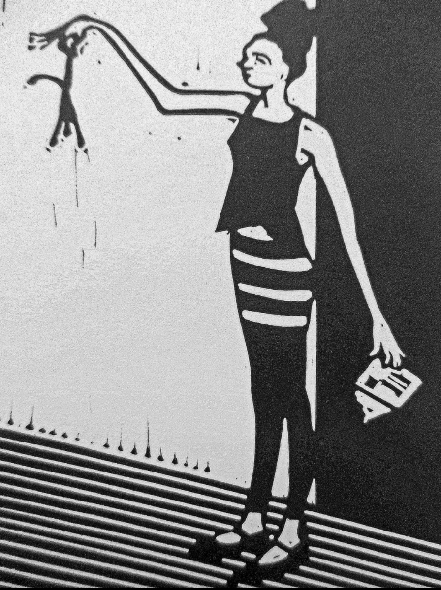 Linocut of a woman known as Bunhead holding up a floppy paper man disdainfully. An envelope lies on the floor.