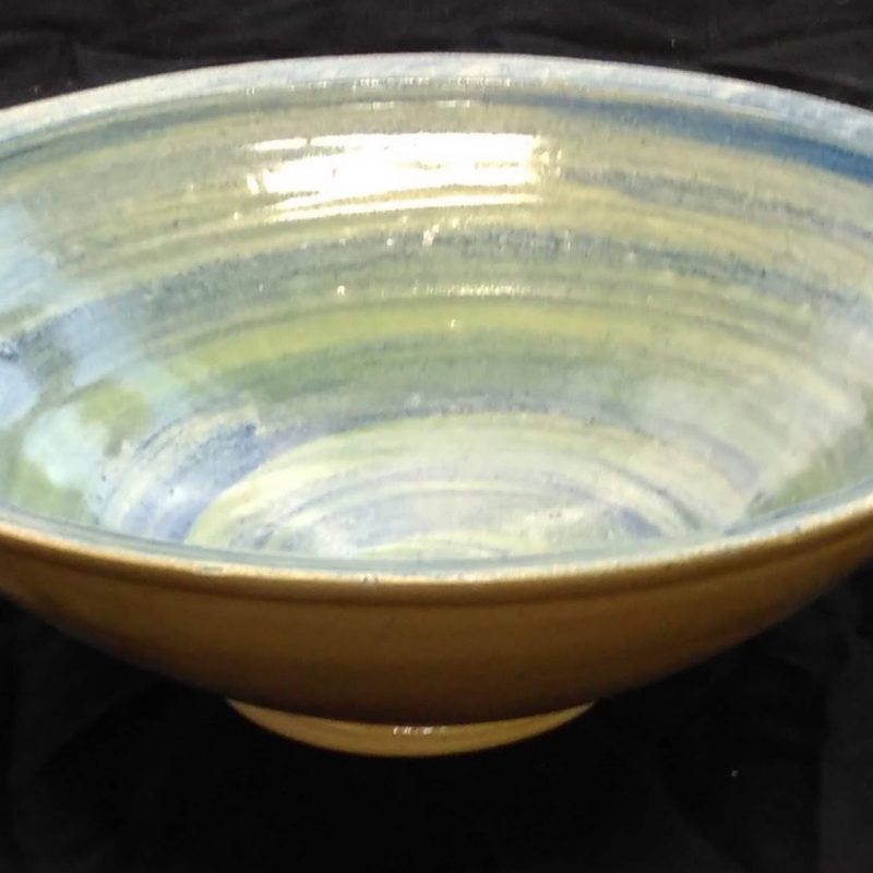 Shallow bowl iron flecked stoneware blue glaze on green slip