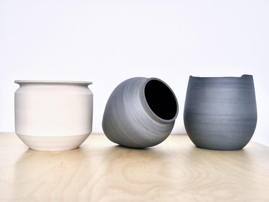 Trio of vases in white, grey and dark grey. 