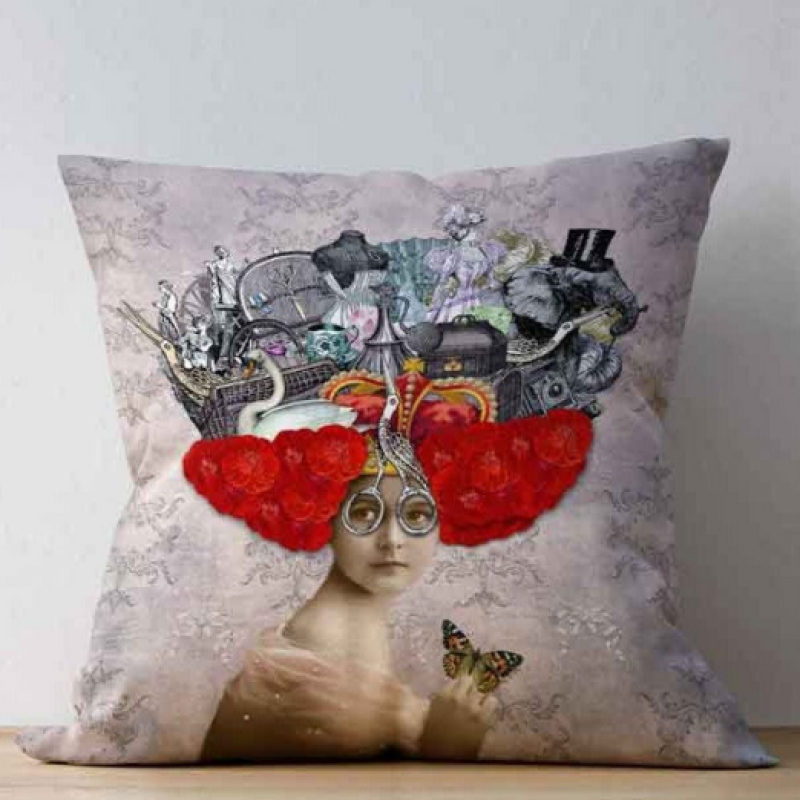 The cushion fabric design is a collection of images from original circa 1900 magazines, books and catalogues,  Collaged together to depict a beautiful young lady with glasses made from Stork figured sewing scissors and  sat upon her hand is a Butterfly, she has bright red hair made from flowers, balanced on the red hair is a crown and images of all the things she loves and dreams about and wants to own. Among these images are Leather bags, Ostrich feathers, Jewellery, Dresses, Fans, Perfume bottles, Ceramics, Gems and much more. 
