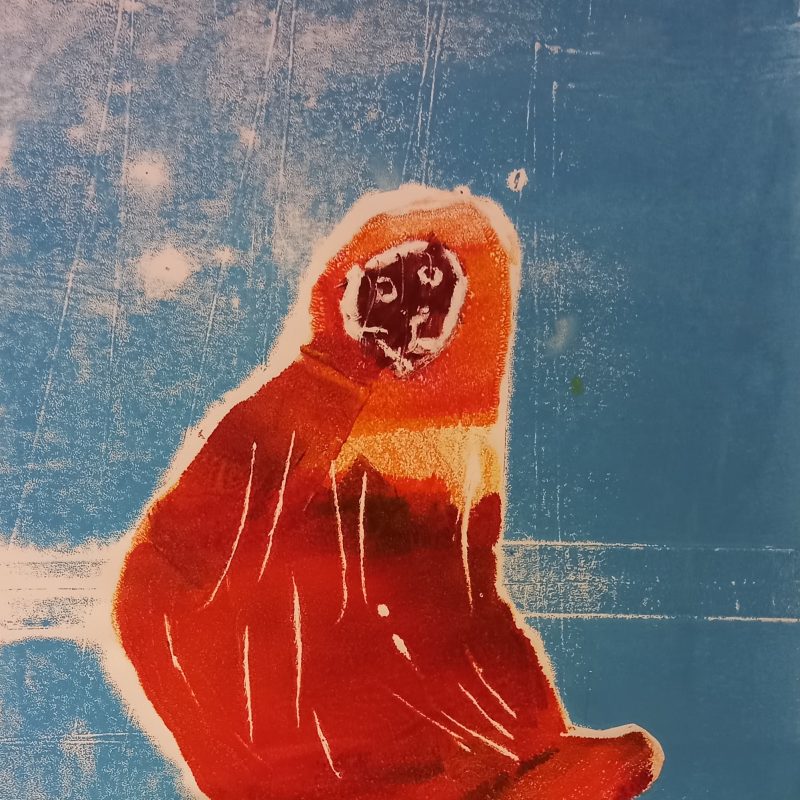 Orange/brown monkey on a blue background