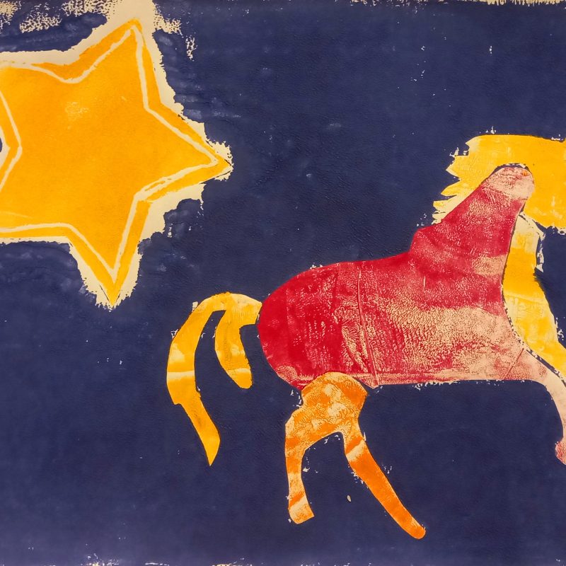 Large orange star and a red and orange horse on a deep blue background