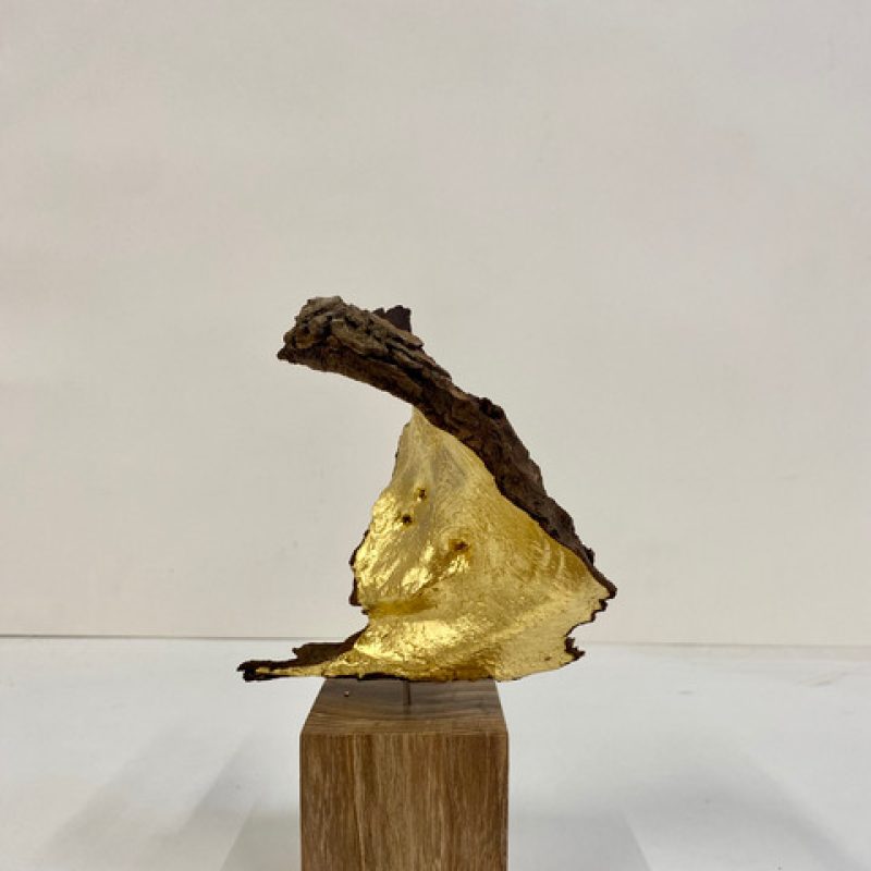  piece of gilded bark mounted on a wooden pedistal