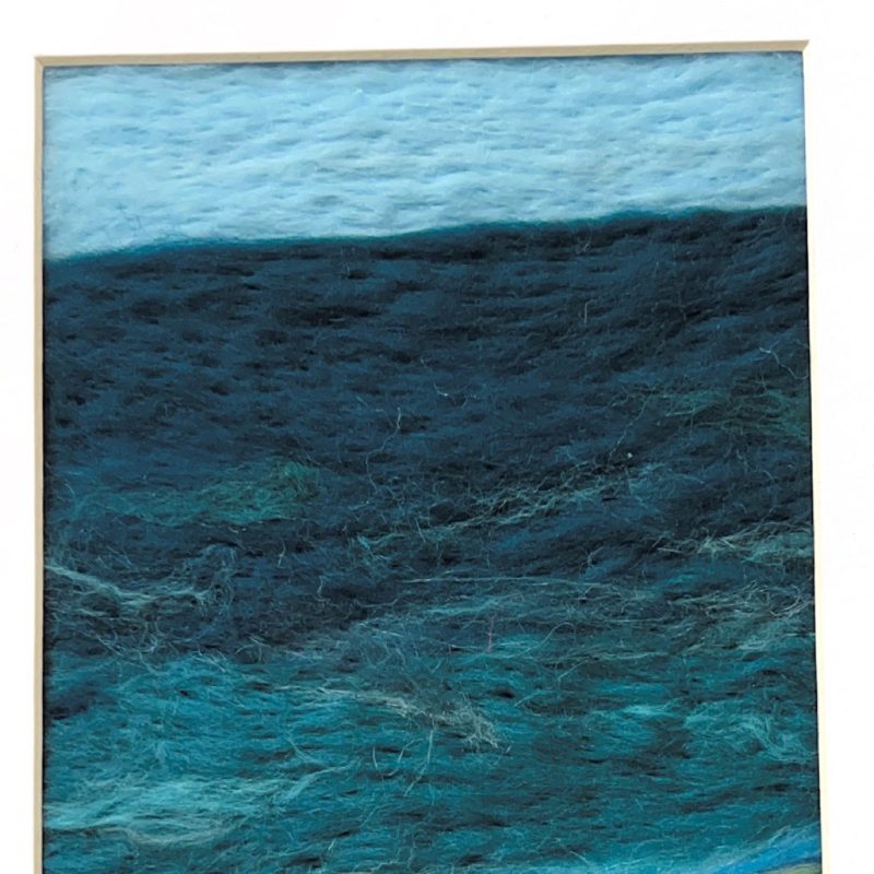Textured image of the sea and beach in colours of blue and deep turquiose