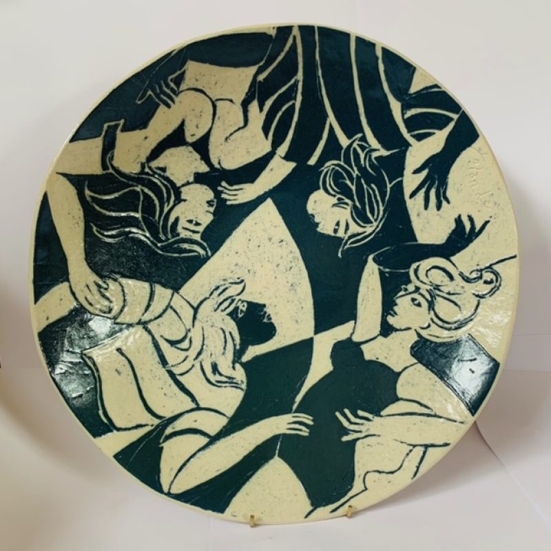A ceramic dish featuring the torsos of swimmers drawn in a vibrant style in monochrome.