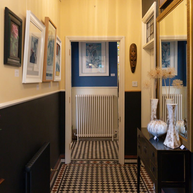 A picture of the inner hall at Art in Bloom showing a selection of paintings and sculptures