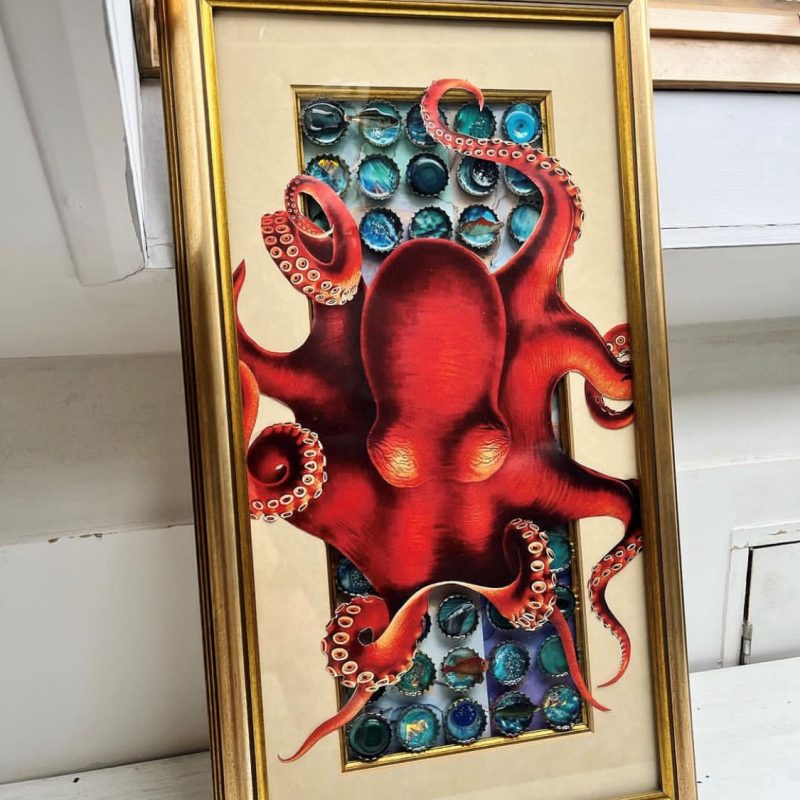 Gold frame with recycled bottle caps filled with recycled materials / resin and a large collage octopus - orange. 