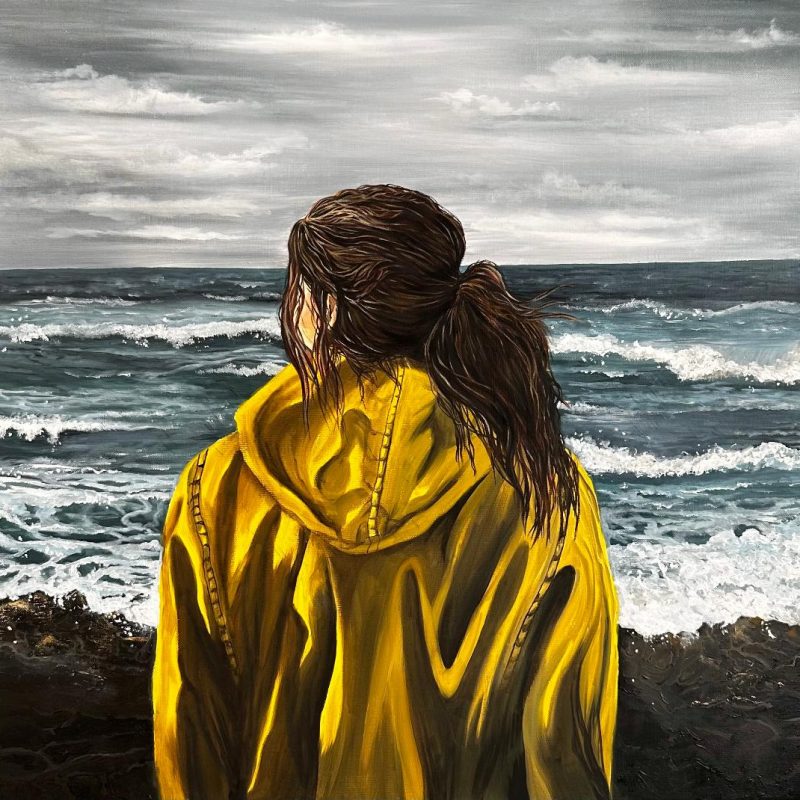 In this evocative painting, a lone girl stands resolute behind a rugged rock barrier, her gaze fixed upon the churning, rolling waves in the distance. The ominous grey sky signals an impending tempest, but she remains undaunted, draped in a bright yellow fisherman's raincoat that stands out boldly against the somber backdrop. Her presence embodies a poignant contrast, symbolising human vulnerability in the face of nature's might. Yet, her steadfast stance and the determined set of her shoulders convey a silent, unyielding connection with the sea, offering a powerful reminder of our enduring relationship with the untamed forces of the world.
