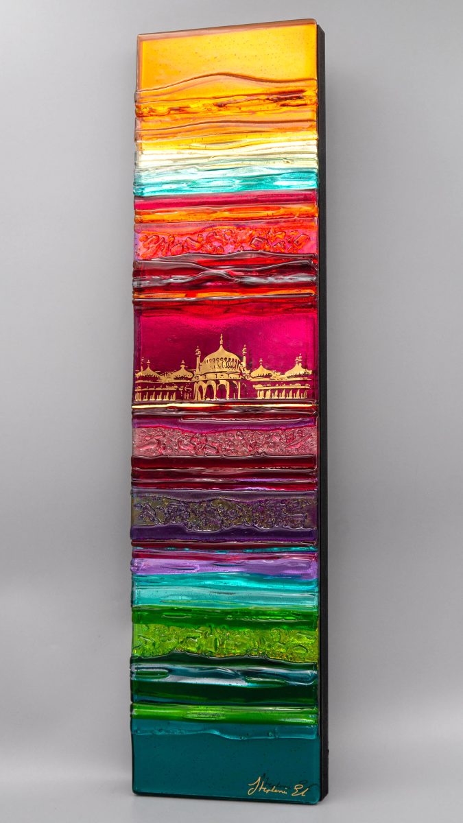 A textured glass panel in shades of green, pink orange and purple with an abstract image of the Royal Pavilion in shiny 22ct gold