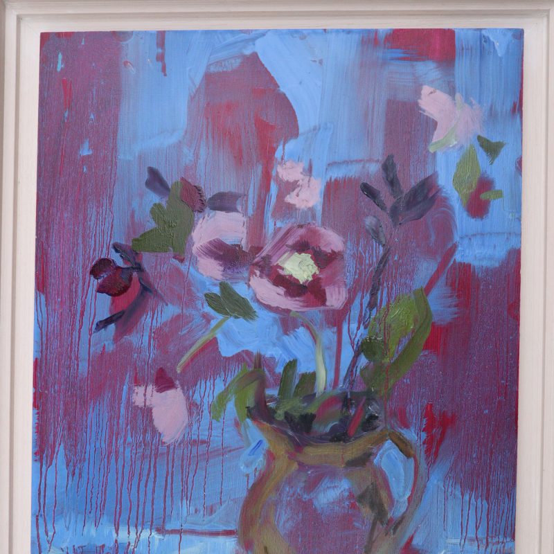 Flowers in a vase agaist a bright blue background