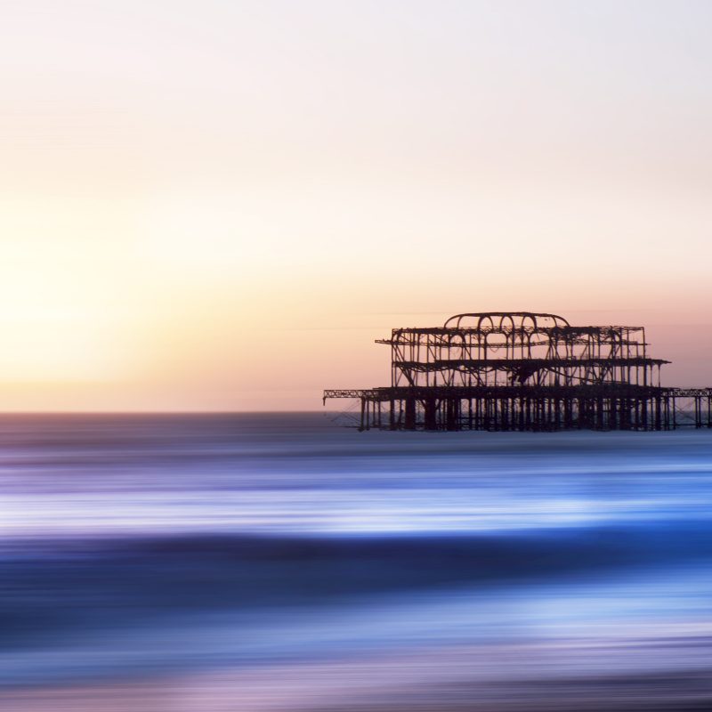 West Pier at sunset with an orange glow behind