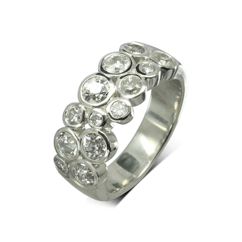 A contemporary Bubbles Platinum Diamond Eternity Ring, with two rows of diamonds in a variety of sizes for a natural look and brilliant shine.