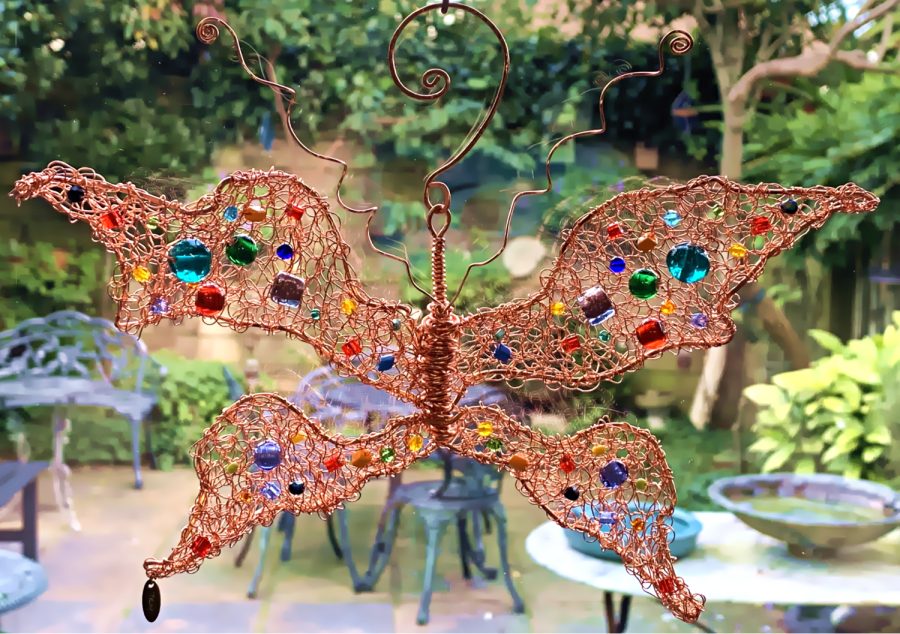 Hand Crochet Copper Butterfly sculpture hanging with colTroourful glass on the wings by Troy Ohlson