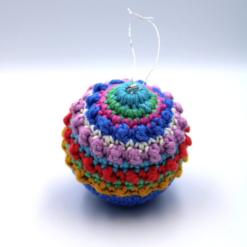 A multi coloured crochet bauble