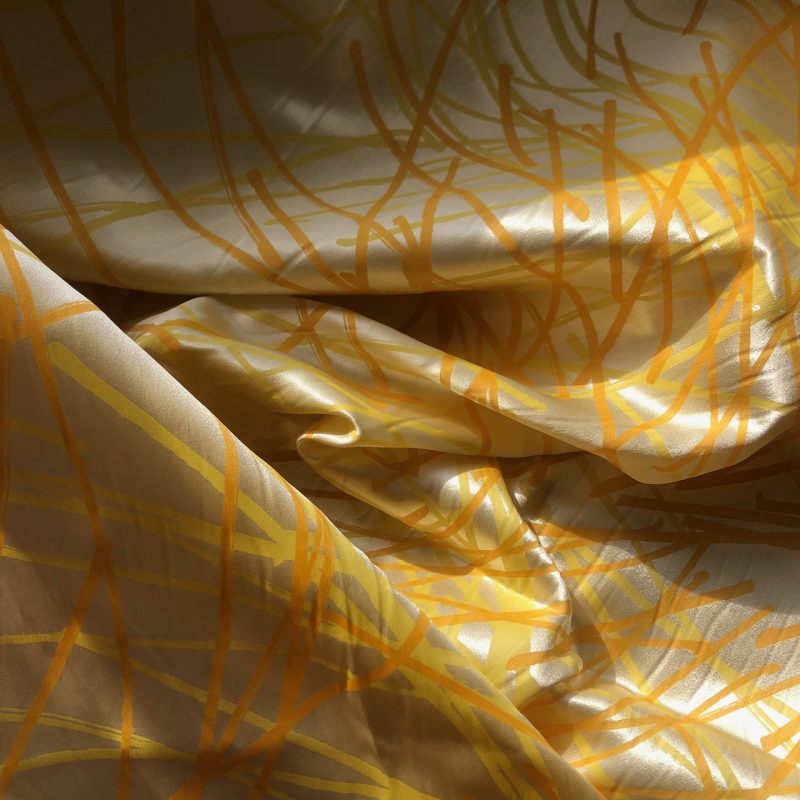 Lemon yellow multi directional print on silk crepe satin.