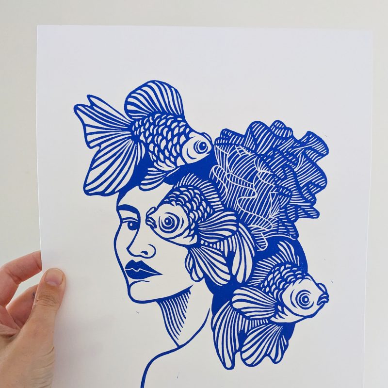 Blue line illustration of a woman with fish forming her hair