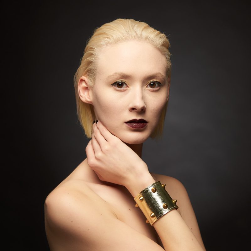 Gold leather cuff with cone shaped brass studs