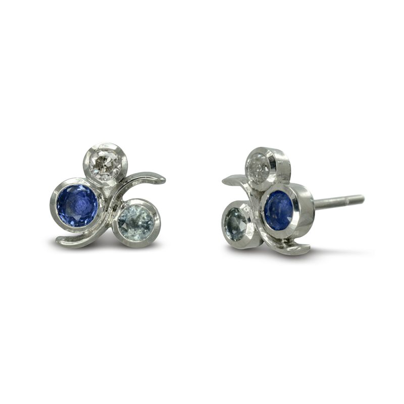 Sapphire Wave Earstuds in platinum pictured set with a 3.5mm blue sapphire, a 3mm teal sapphire and a 2.5mm round diamond. Available with a pink, golden or Blue coloured centre sapphire