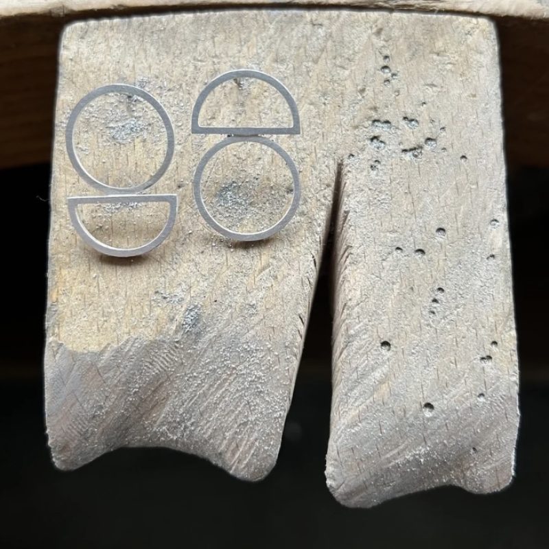 A pair of geometric silver stud earrings