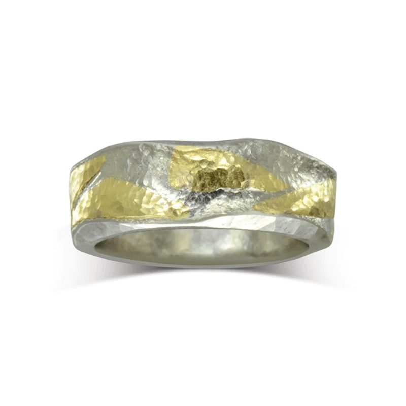 An 8mm wide hammered platinum band with 18ct yellow gold pieces hammered into the surface.