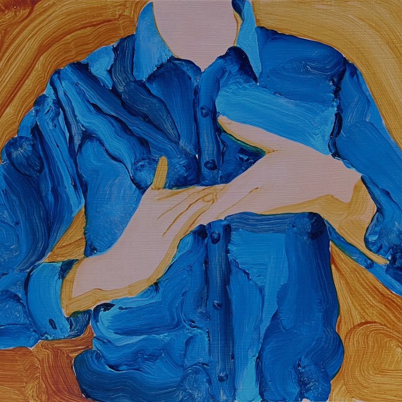 Upper torso wearing blue shirt, tension created between two hands