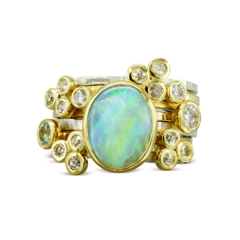 A stacking ring with clusters of round diamonds around a central oval opal