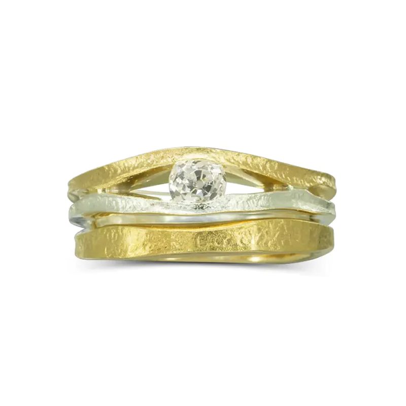 A rough textured white and yellow gold two strand ring with a round diamond set between and a matching curved-to-fit wedding ring