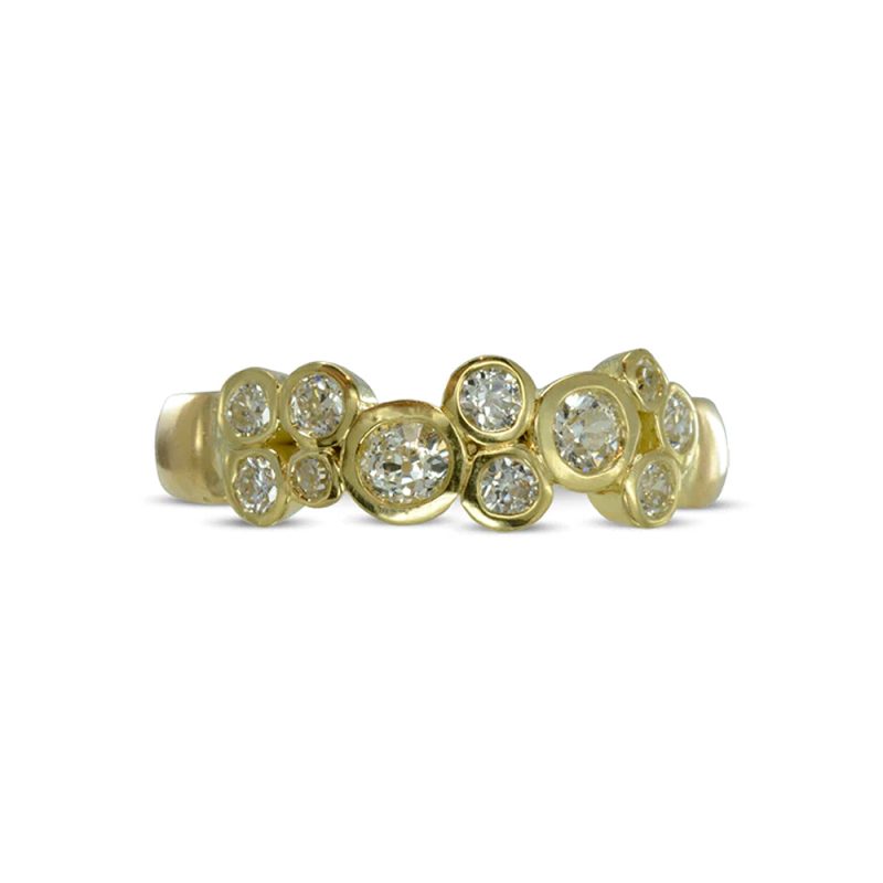 an 18ct yellow gold half eternity ring with varying sizes of round diamonds set in a clustered row like bubbles.